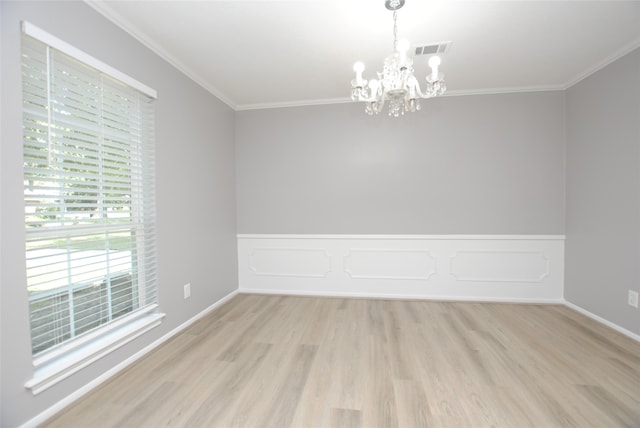 unfurnished room with light hardwood / wood-style floors, a notable chandelier, and ornamental molding