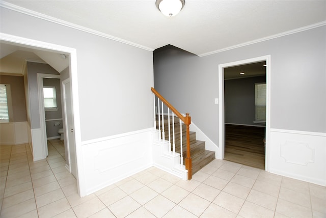 stairway featuring wood-type flooring and ornamental molding