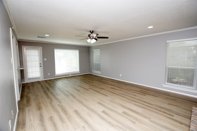 unfurnished room featuring a textured ceiling, ceiling fan, ornamental molding, and light hardwood / wood-style floors