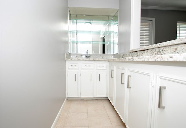 bathroom with crown molding, vanity, tile patterned floors, and a shower with door