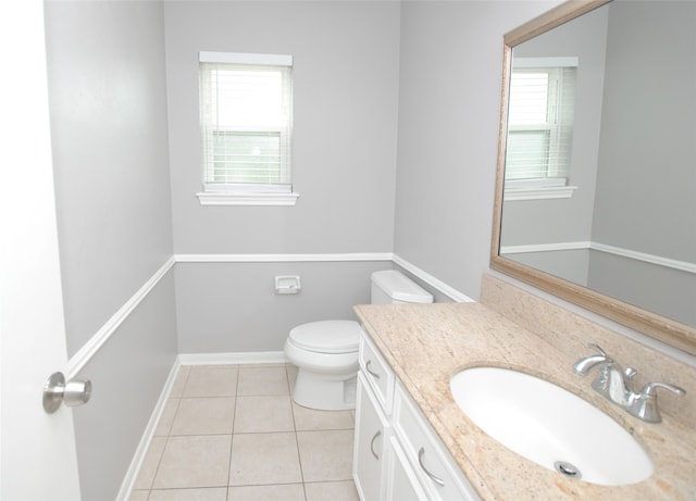 bathroom with vanity, toilet, and tile patterned flooring