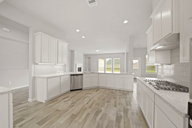 kitchen featuring sink, white cabinets, stainless steel appliances, and light hardwood / wood-style floors