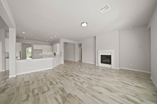 unfurnished living room with light hardwood / wood-style flooring