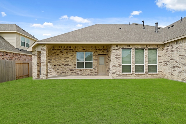 back of property featuring a lawn and a patio area