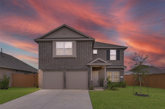 front of property with a garage and a lawn