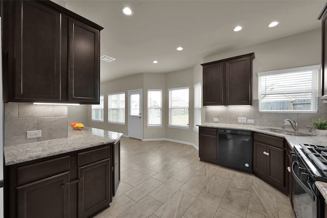 kitchen featuring plenty of natural light, sink, tasteful backsplash, and black appliances