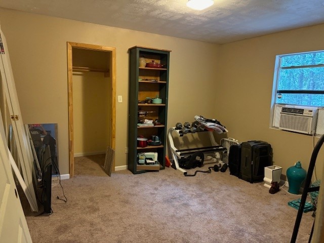 miscellaneous room with cooling unit, light colored carpet, and a textured ceiling