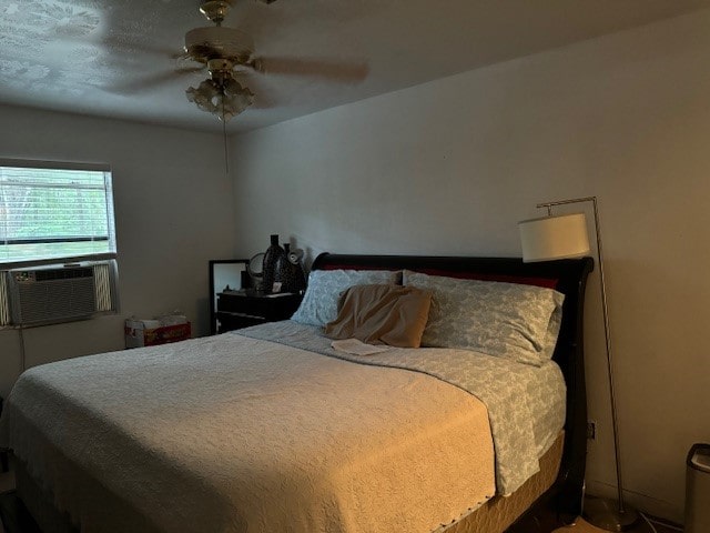 bedroom featuring cooling unit and ceiling fan