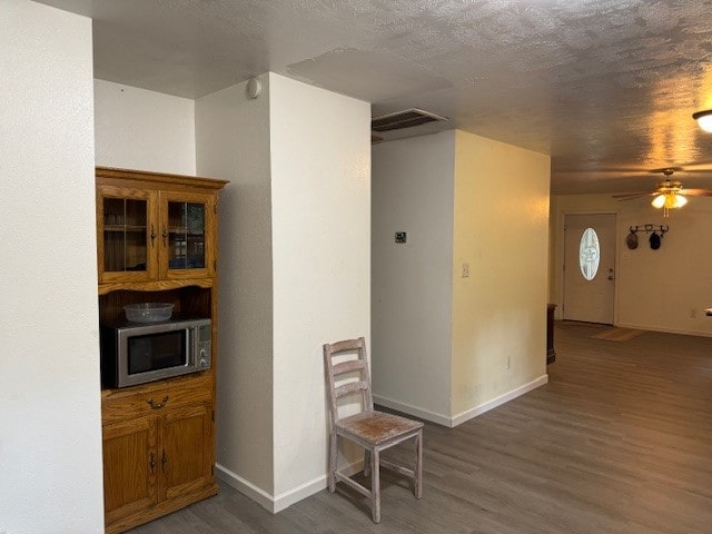 interior space featuring a textured ceiling and dark hardwood / wood-style flooring