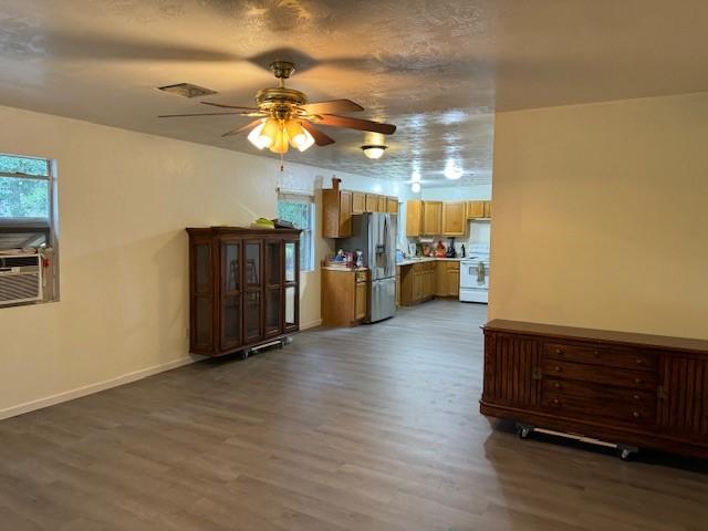 interior space with hardwood / wood-style floors, ceiling fan, and a textured ceiling