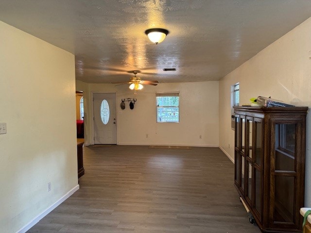 unfurnished living room featuring hardwood / wood-style flooring and ceiling fan