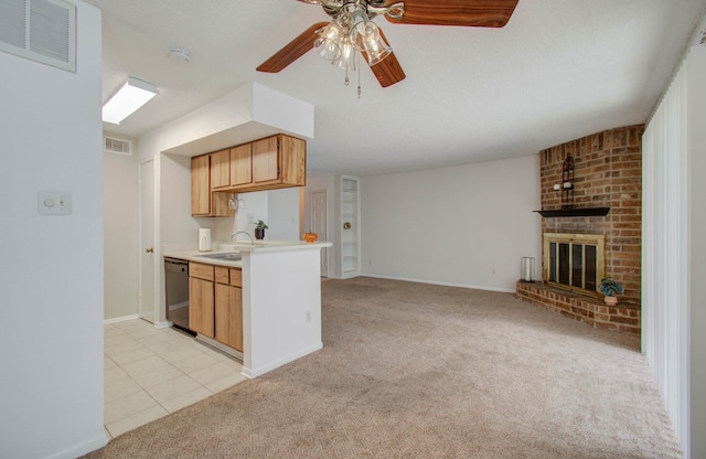 kitchen featuring light carpet, a fireplace, sink, ceiling fan, and black dishwasher