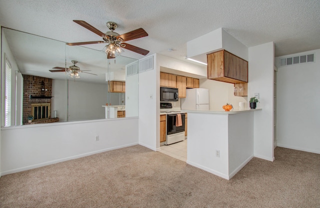 kitchen featuring light carpet, white appliances, kitchen peninsula, and ceiling fan