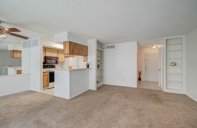 kitchen featuring white appliances, light colored carpet, a textured ceiling, and ceiling fan