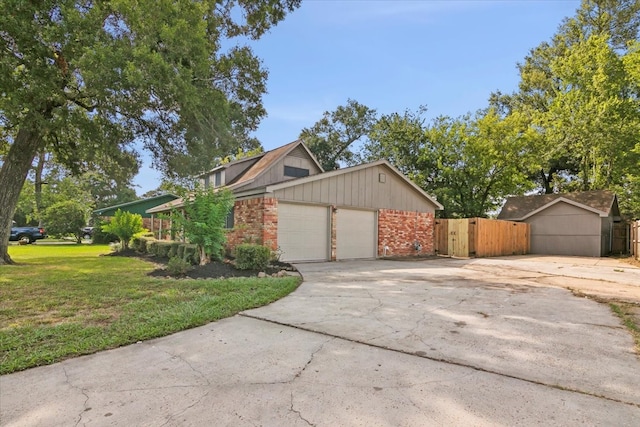 view of front of property featuring a garage and a front lawn