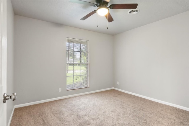 unfurnished room with ceiling fan and light colored carpet