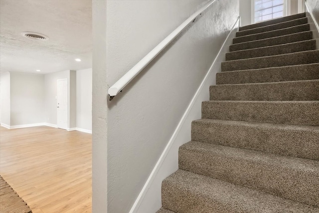 stairs with wood-type flooring