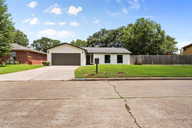 ranch-style house featuring a garage and a front lawn