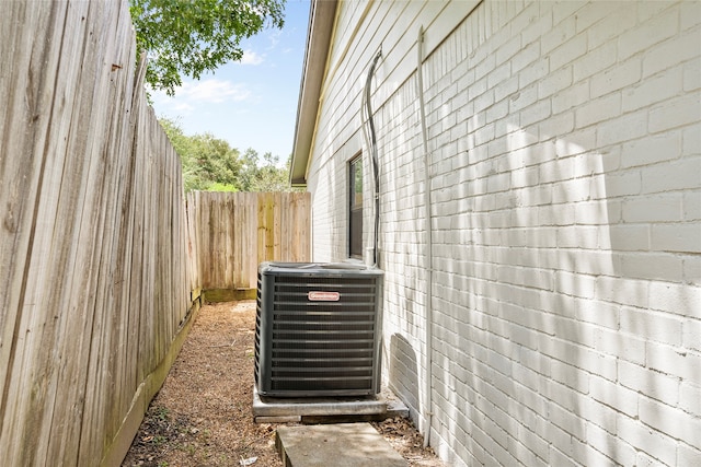 view of side of home with central AC