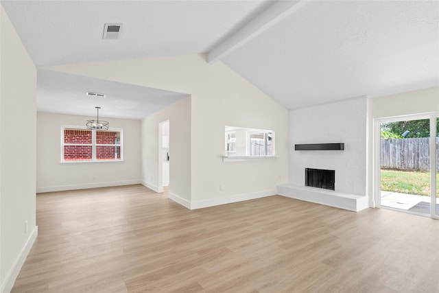 unfurnished living room featuring light hardwood / wood-style floors, a notable chandelier, vaulted ceiling with beams, and a fireplace