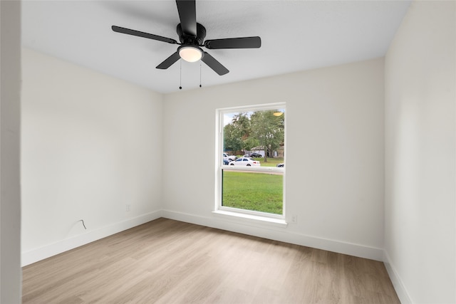 empty room featuring a wealth of natural light, light hardwood / wood-style flooring, and ceiling fan