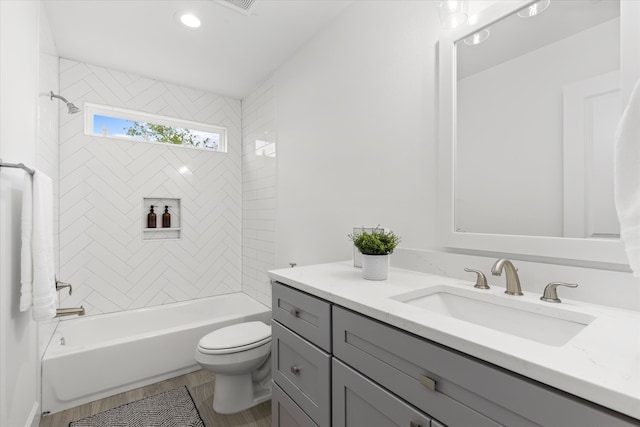 full bathroom with tiled shower / bath combo, toilet, and vanity