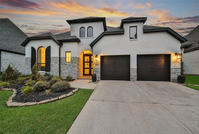 french country home with a garage and a yard