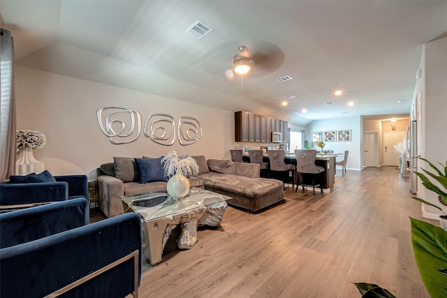 living room featuring light wood-type flooring and ceiling fan