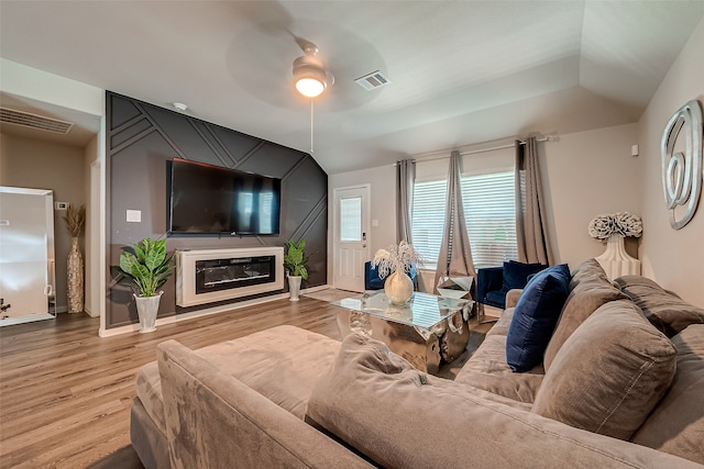 living room featuring lofted ceiling, wood-type flooring, and ceiling fan