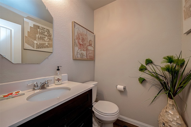 bathroom featuring toilet and vanity