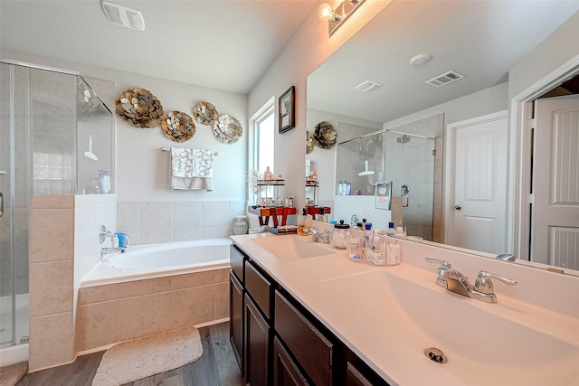 bathroom with hardwood / wood-style floors, separate shower and tub, and vanity