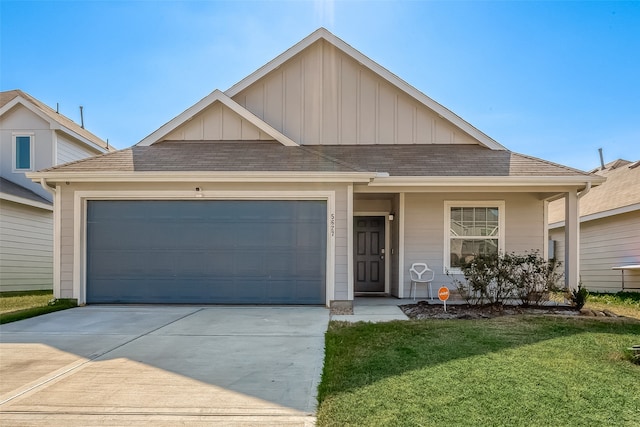 view of front of home with a garage and a front lawn