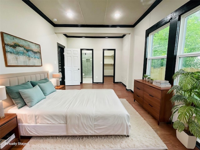 bedroom featuring hardwood / wood-style flooring and crown molding