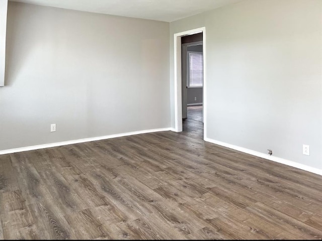 unfurnished room featuring dark hardwood / wood-style flooring