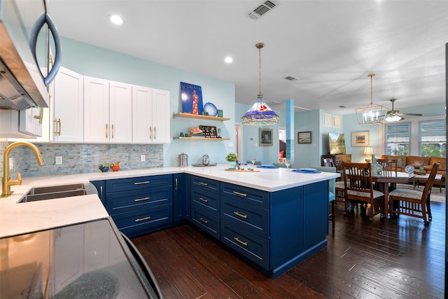 kitchen with pendant lighting, dark wood-type flooring, ceiling fan, and white cabinetry