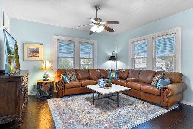 living room featuring ceiling fan, dark hardwood / wood-style floors, and a healthy amount of sunlight