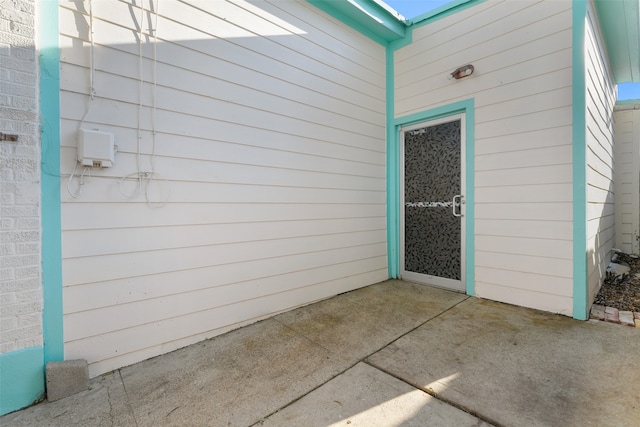 entrance to property featuring a patio area