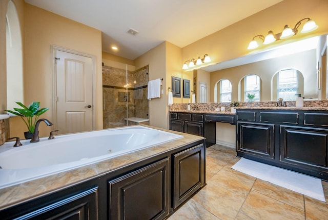 bathroom with double vanity, a stall shower, visible vents, a whirlpool tub, and a sink