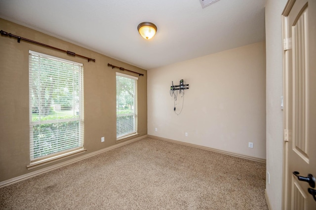 spare room with carpet floors and baseboards