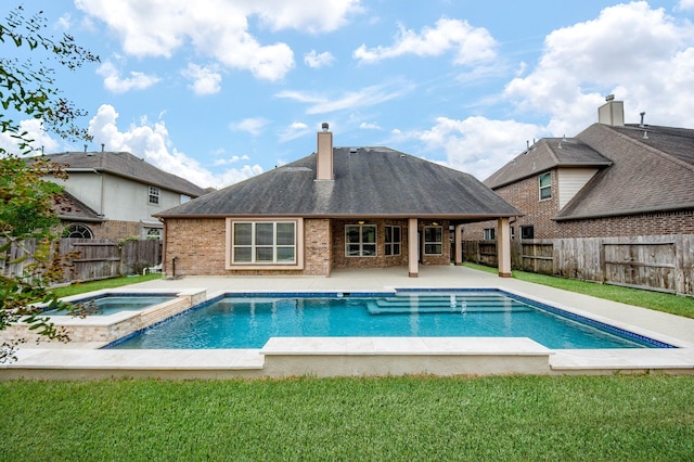 view of swimming pool with a yard, a patio, a fenced backyard, and a pool with connected hot tub