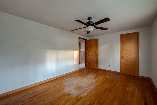 unfurnished bedroom featuring ceiling fan and hardwood / wood-style flooring