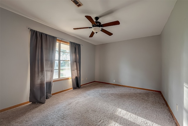 spare room featuring ceiling fan and carpet floors