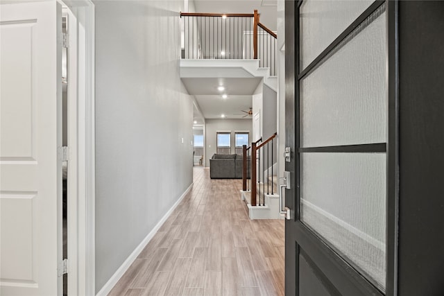 corridor with light hardwood / wood-style flooring