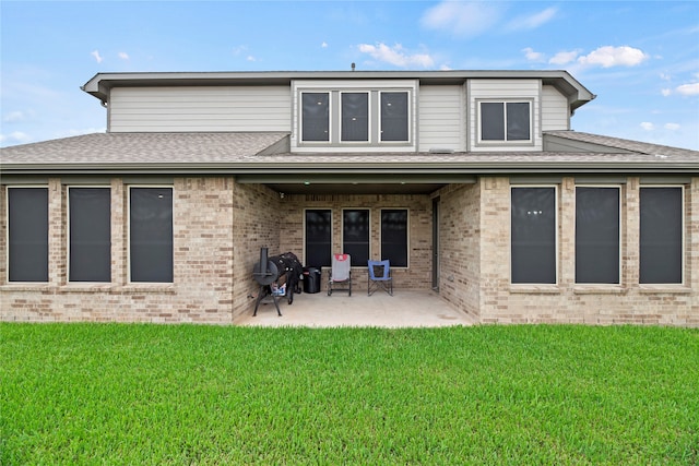 rear view of house with a yard and a patio area