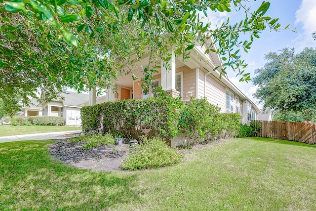 view of side of property with a yard