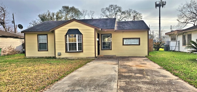 bungalow-style home with a front lawn