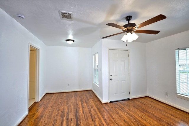 empty room featuring ceiling fan and dark hardwood / wood-style flooring