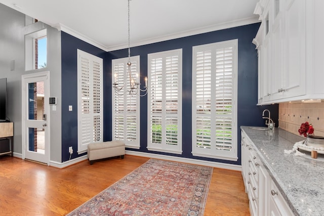 kitchen featuring plenty of natural light, light hardwood / wood-style flooring, and white cabinets