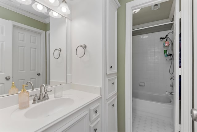 bathroom with tiled shower / bath, crown molding, and vanity