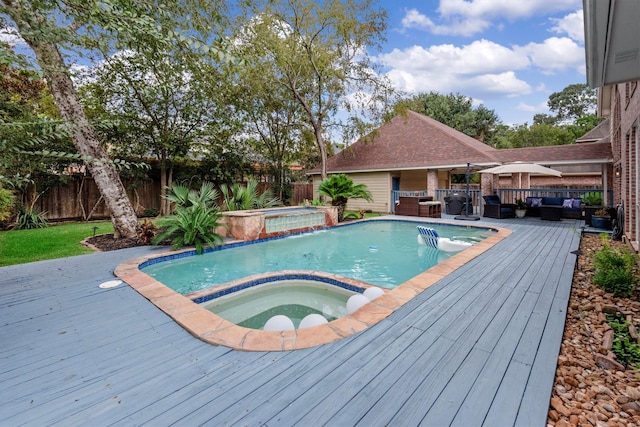 view of swimming pool featuring an in ground hot tub and a deck